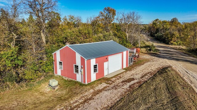 34257 Dusty Trl, Frazee, MN 56544 - view of outdoor structure with driveway and a forest view