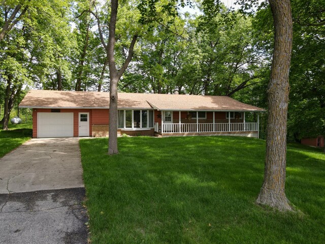 34257 Dusty Trl, Frazee, MN 56544 - view of front of home with a porch, driveway, a garage, and a front yard