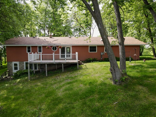 34257 Dusty Trl, Frazee, MN 56544 - back of property featuring a deck, a yard, central air condition unit, and a chimney