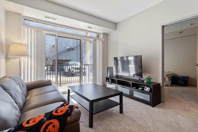 living room with light carpet, visible vents, and a wealth of natural light