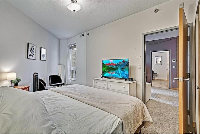 bedroom featuring lofted ceiling, light colored carpet, and a textured ceiling