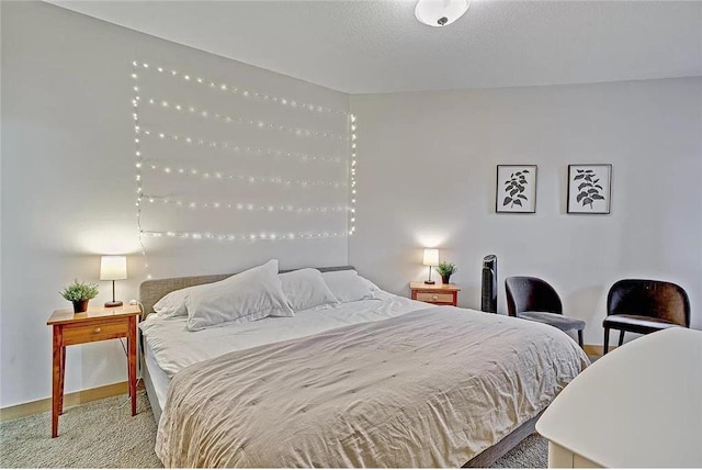 carpeted bedroom featuring a textured ceiling