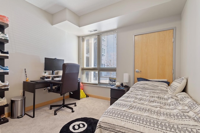 carpeted bedroom with visible vents and baseboards