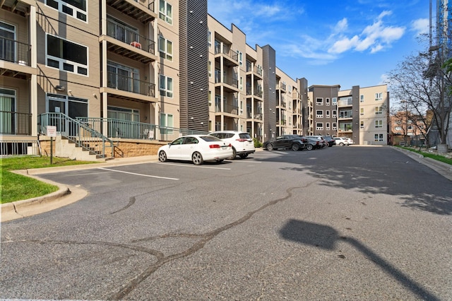 view of building exterior with uncovered parking