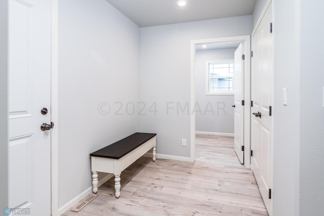 hallway featuring light wood-style flooring, recessed lighting, visible vents, and baseboards