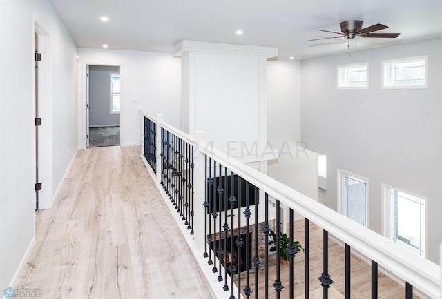 hallway featuring recessed lighting, baseboards, and wood finished floors