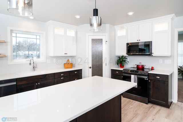 kitchen featuring a sink, light countertops, white cabinetry, and stainless steel appliances