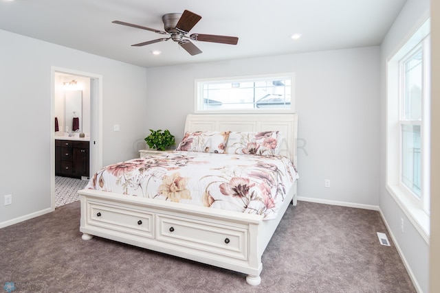 bedroom with dark carpet, baseboards, and multiple windows