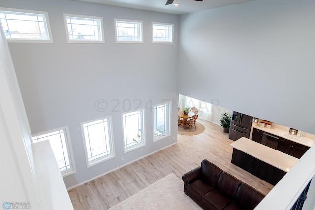 living room featuring wood finished floors and ceiling fan