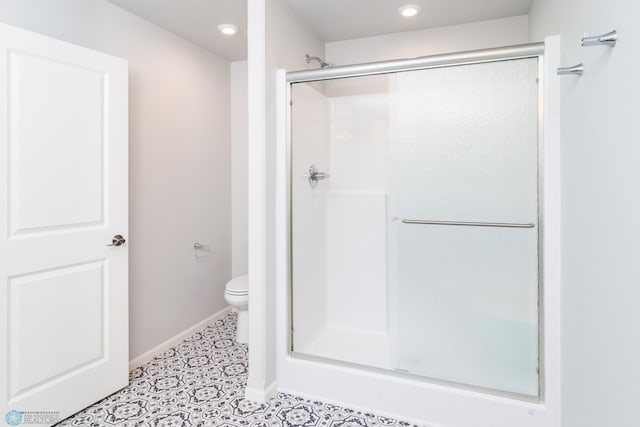 full bath with recessed lighting, a shower stall, and toilet