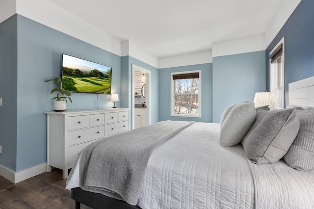 bedroom featuring baseboards and dark wood finished floors