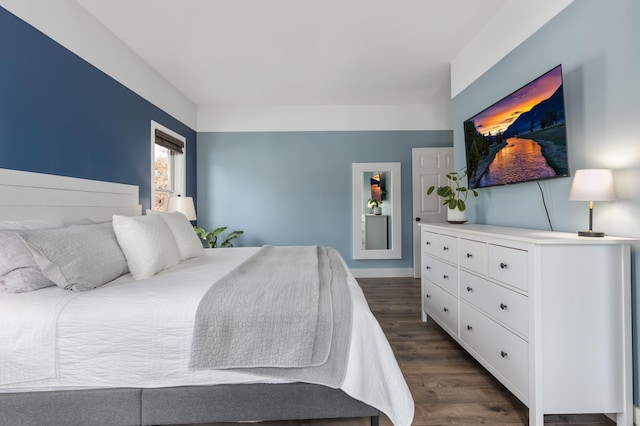 bedroom with dark wood-style flooring