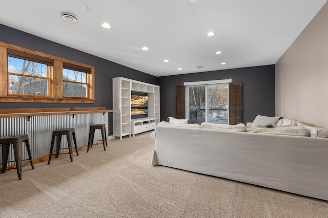 carpeted living room featuring baseboards and recessed lighting