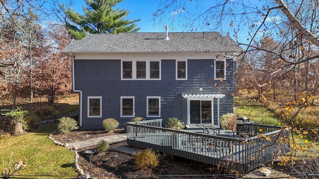 back of house with a shingled roof and a wooden deck