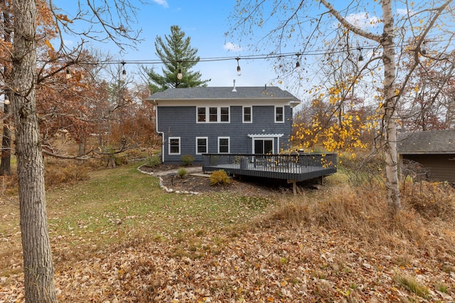 back of house featuring a deck and a yard