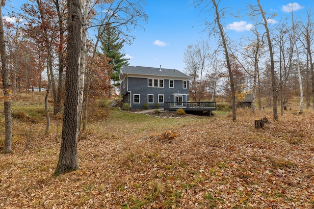 rear view of house featuring a wooden deck