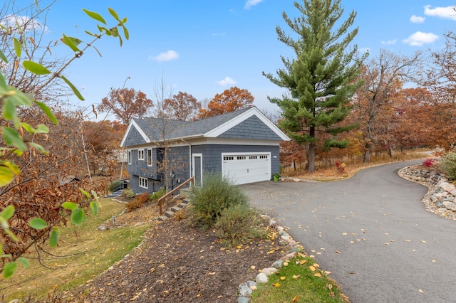 view of property exterior with a garage and aphalt driveway