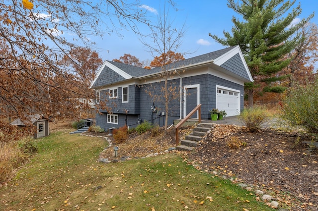 back of house with a yard and an attached garage