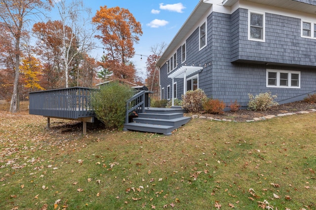 view of home's exterior featuring a lawn and a wooden deck