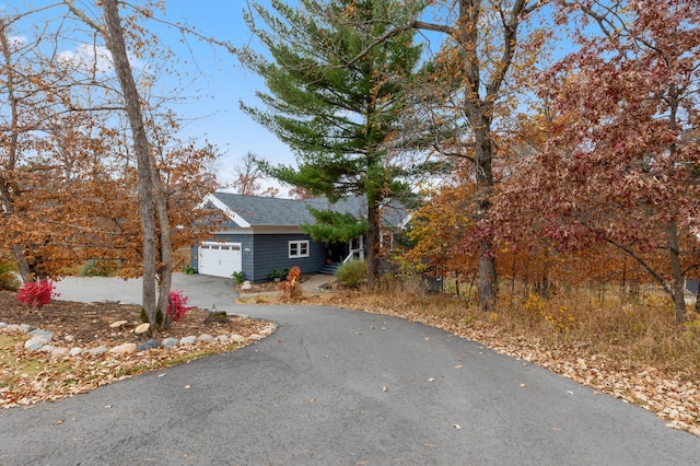 exterior space with aphalt driveway and a garage