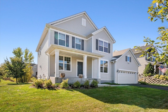 view of front of property with aphalt driveway, a garage, and a front yard