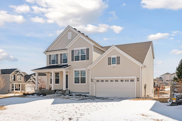 traditional-style home featuring a garage and covered porch