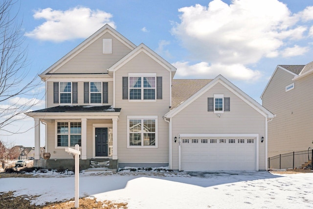 traditional home with fence and a garage