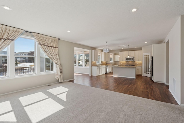 unfurnished living room featuring recessed lighting, baseboards, a textured ceiling, and dark wood-style flooring