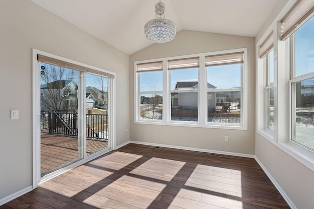 unfurnished sunroom with lofted ceiling, a healthy amount of sunlight, and an inviting chandelier