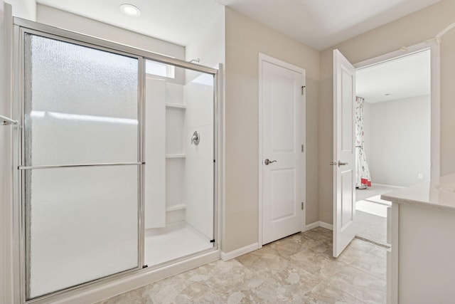 full bathroom with baseboards and a stall shower