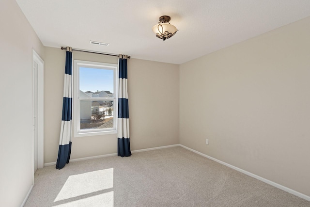 empty room featuring visible vents, baseboards, and carpet flooring