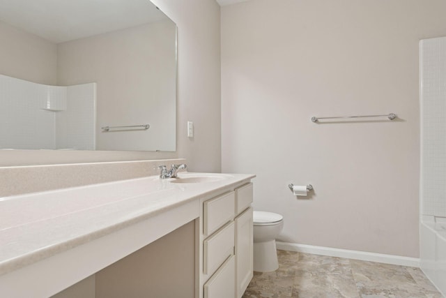 bathroom featuring baseboards, toilet, and vanity