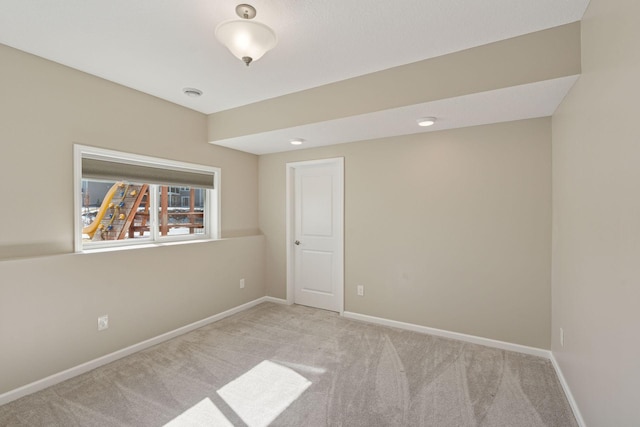 carpeted empty room with baseboards