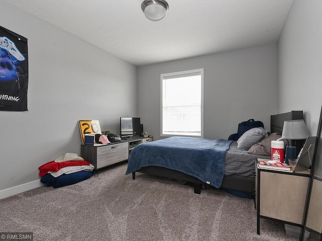 bedroom with carpet flooring and baseboards