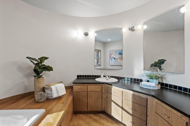 bathroom featuring a textured ceiling and vanity