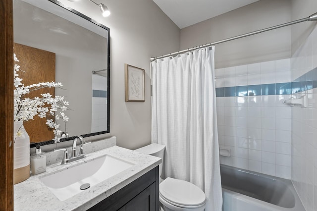 bathroom featuring shower / bath combo, vanity, and toilet