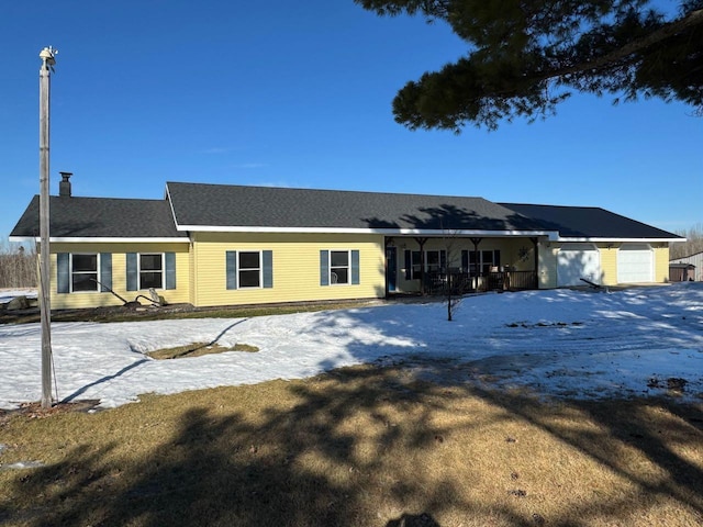 ranch-style home with a garage and a porch