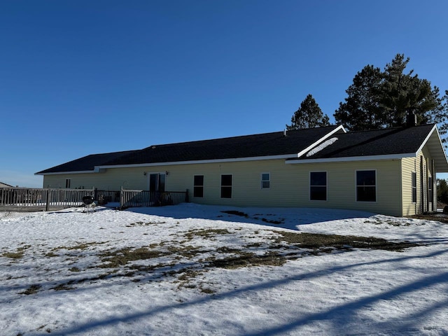 view of snow covered rear of property