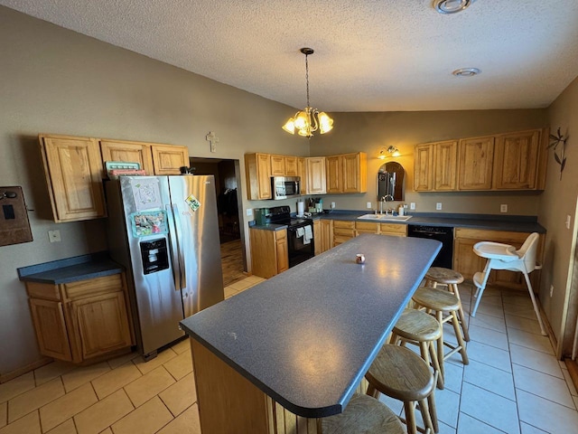 kitchen with lofted ceiling, black appliances, dark countertops, and a sink