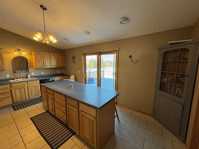 kitchen with light tile patterned floors, a kitchen island, an inviting chandelier, vaulted ceiling, and a sink