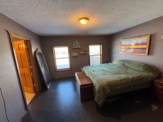 bedroom with a textured wall and a textured ceiling