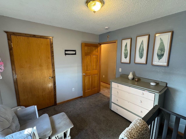 bedroom featuring a textured ceiling, carpet floors, and baseboards