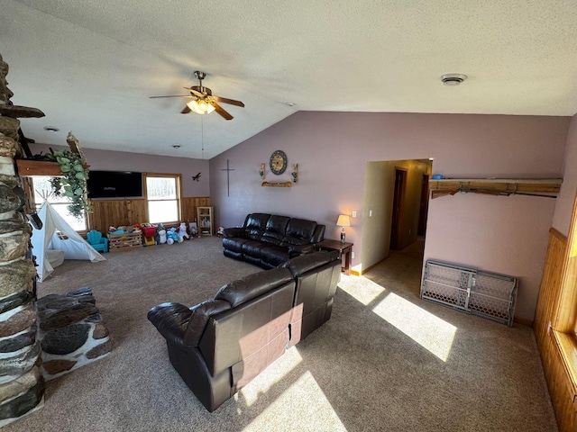 living room featuring a ceiling fan, carpet flooring, vaulted ceiling, and a textured ceiling