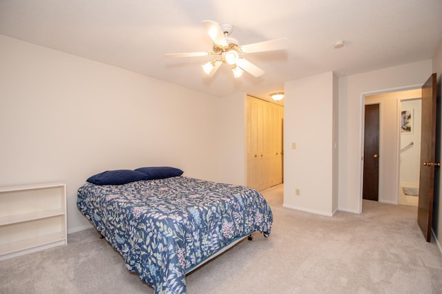 carpeted bedroom with ceiling fan, a closet, and baseboards