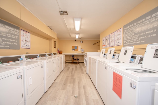 shared laundry area featuring light wood-type flooring and washing machine and clothes dryer