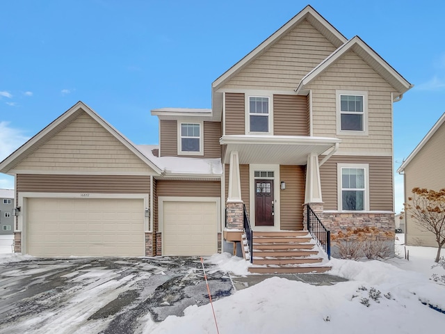 view of front of house featuring a garage and stone siding