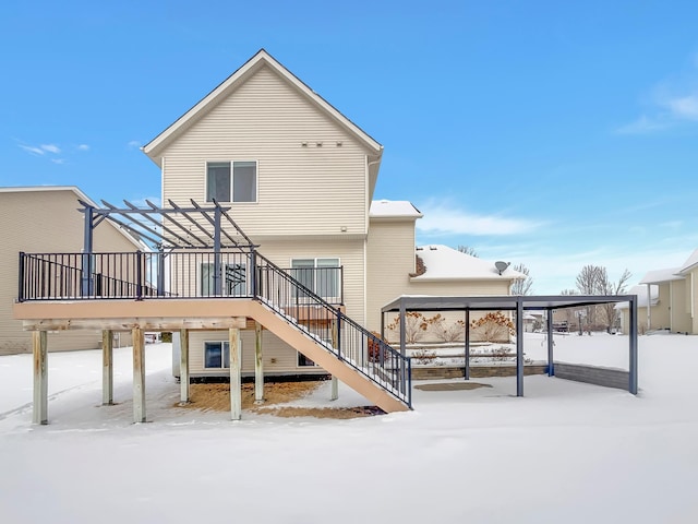 snow covered house featuring stairway, a wooden deck, and a pergola