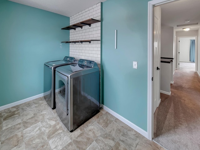 laundry room featuring laundry area, washer and clothes dryer, and baseboards