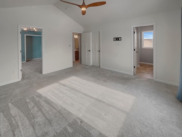 unfurnished bedroom with ceiling fan, baseboards, vaulted ceiling, a spacious closet, and carpet