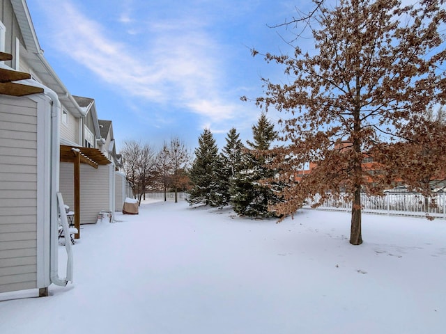 yard covered in snow with fence